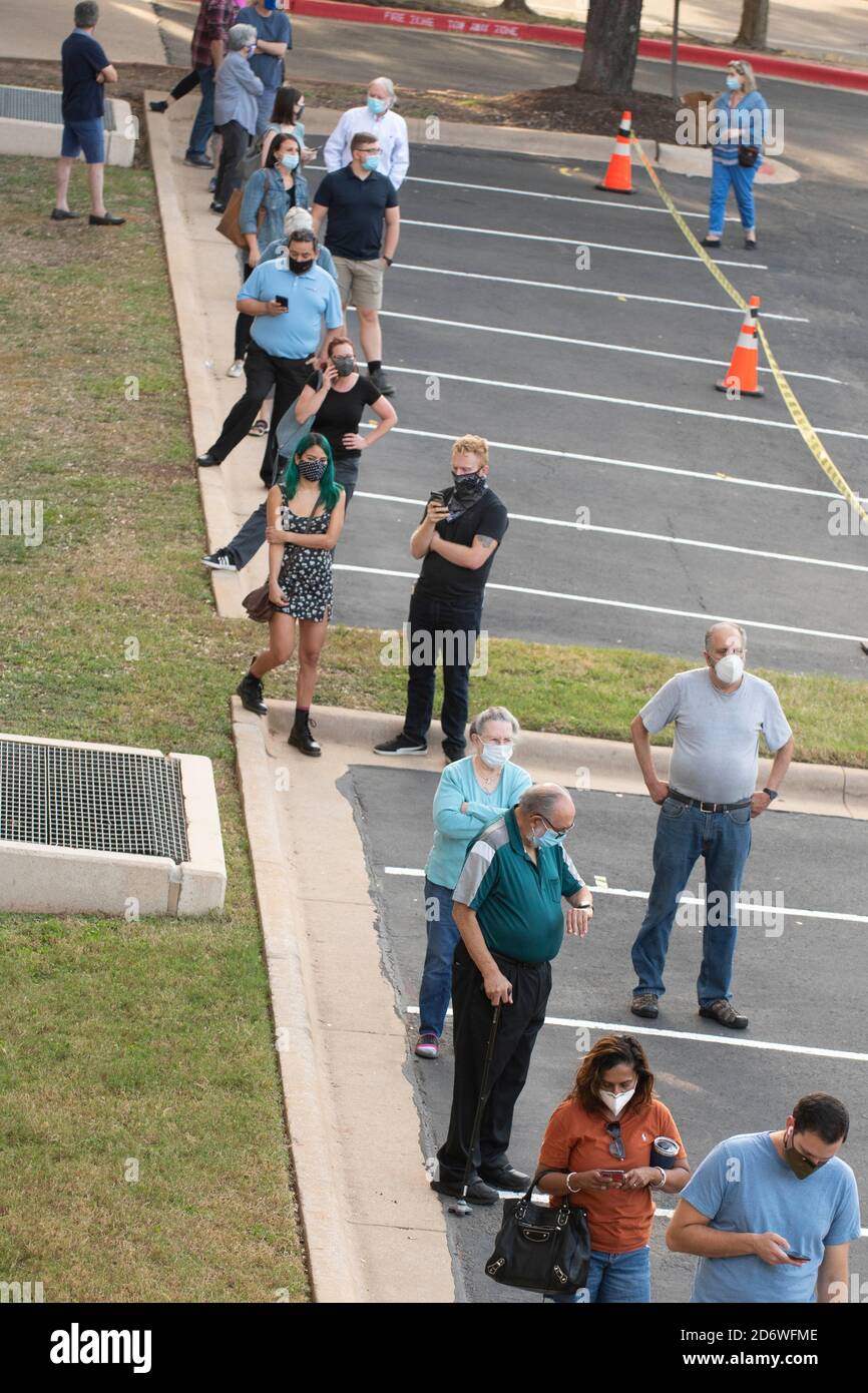 Austin, Texas USA, Oct. 13 2020: Masked-up Texans wait patiently in line at the Arboretum area of north Austin at an early voting site to cast ballots in the 2020 presidential election. Officials are reporting record numbers of early voters with almost 40,000 per day citywide. Stock Photo