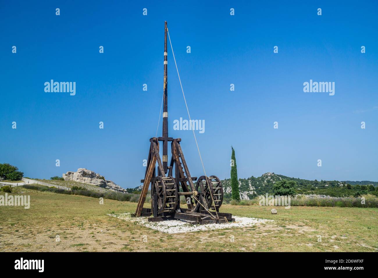 medieval trebuchet catapult siege engine displayed at the ruined castle of Château des Baux-de-Provence, Bouches-du-Rhône department, Southern France Stock Photo