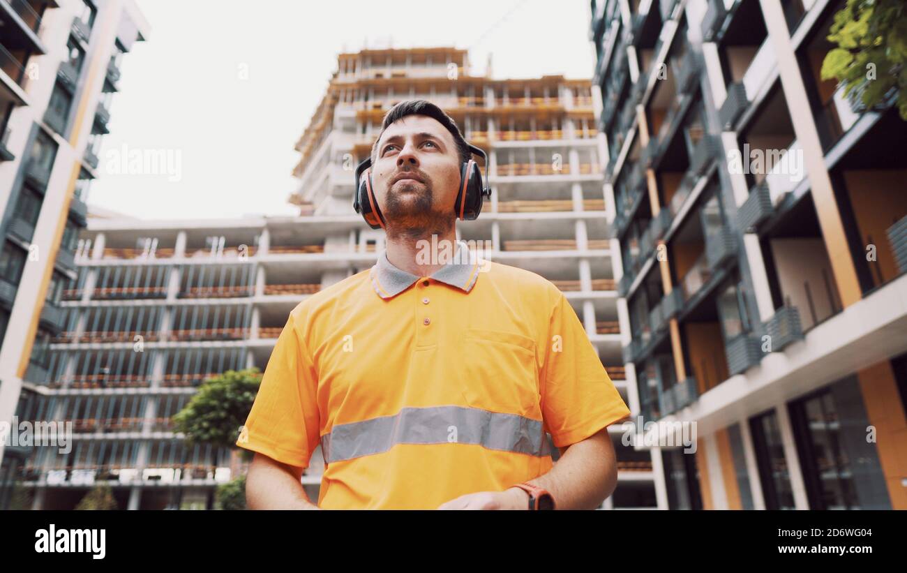Man wearing safety equipment hearing protection. Worker wearing noise