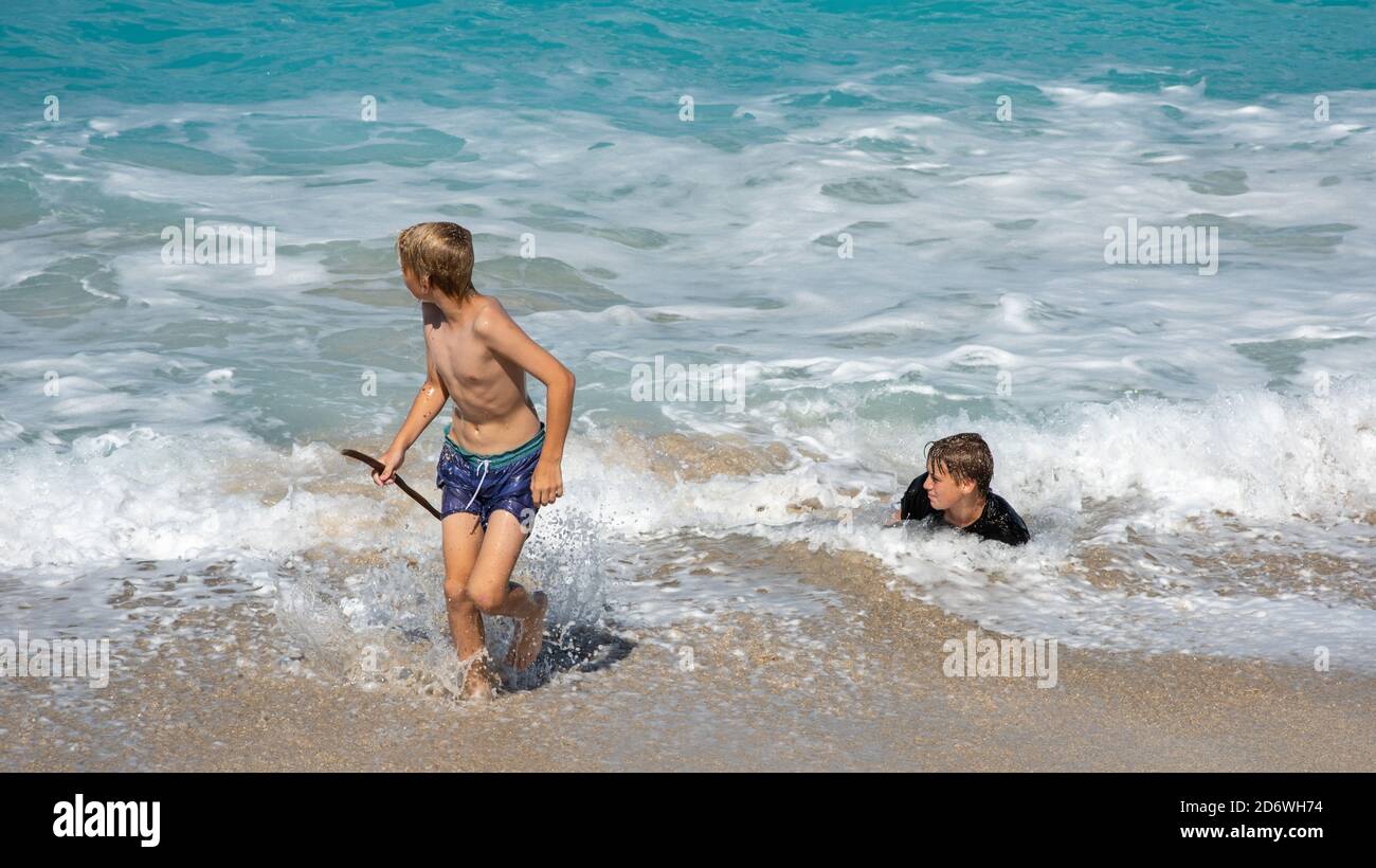 Frederiksted, St. Croix, US Virgin Islands-December 22,2019: Tourists bodysurfing at Sandy Point beach with blue Caribbean Sea waters on St. Croix Stock Photo