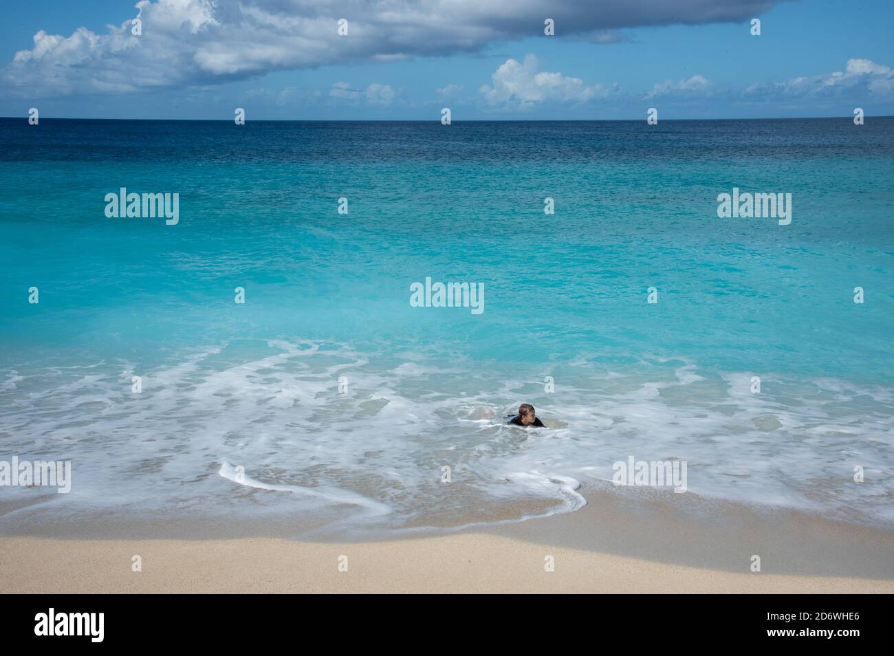 Frederiksted, St. Croix, US Virgin Islands-December 22,2019: Tourist bodysurfing at Sandy Point beach with pure blue Caribbean Sea waters on St. Croix Stock Photo