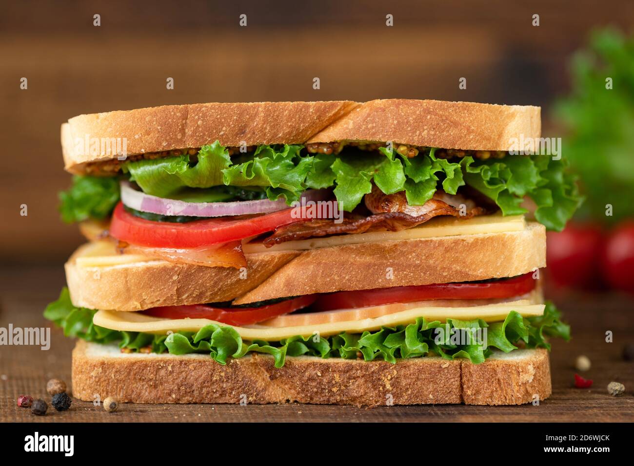 Club Sandwich with bacon cheese tomato lettuce. Tasty unhealthy