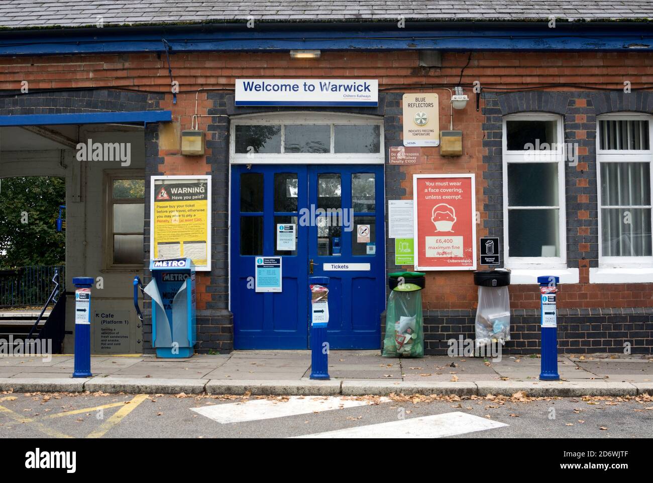 Entrance to Warwick railway station with Covid19 notice, Warwickshire