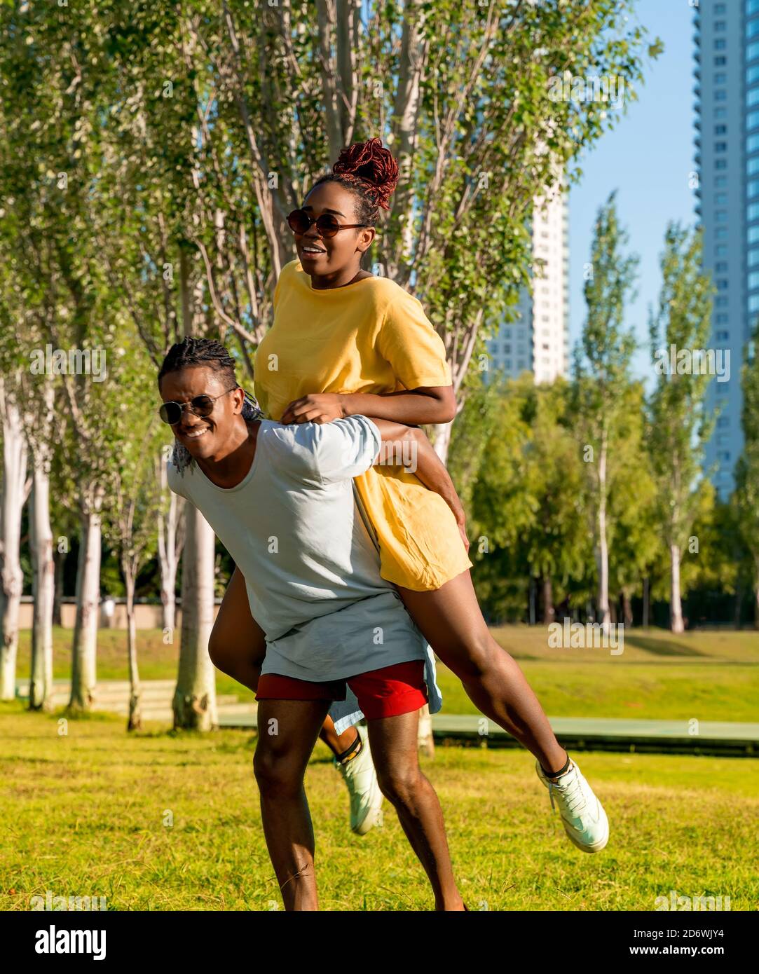 Couple playing piggyback ride in park Stock Photo - Alamy