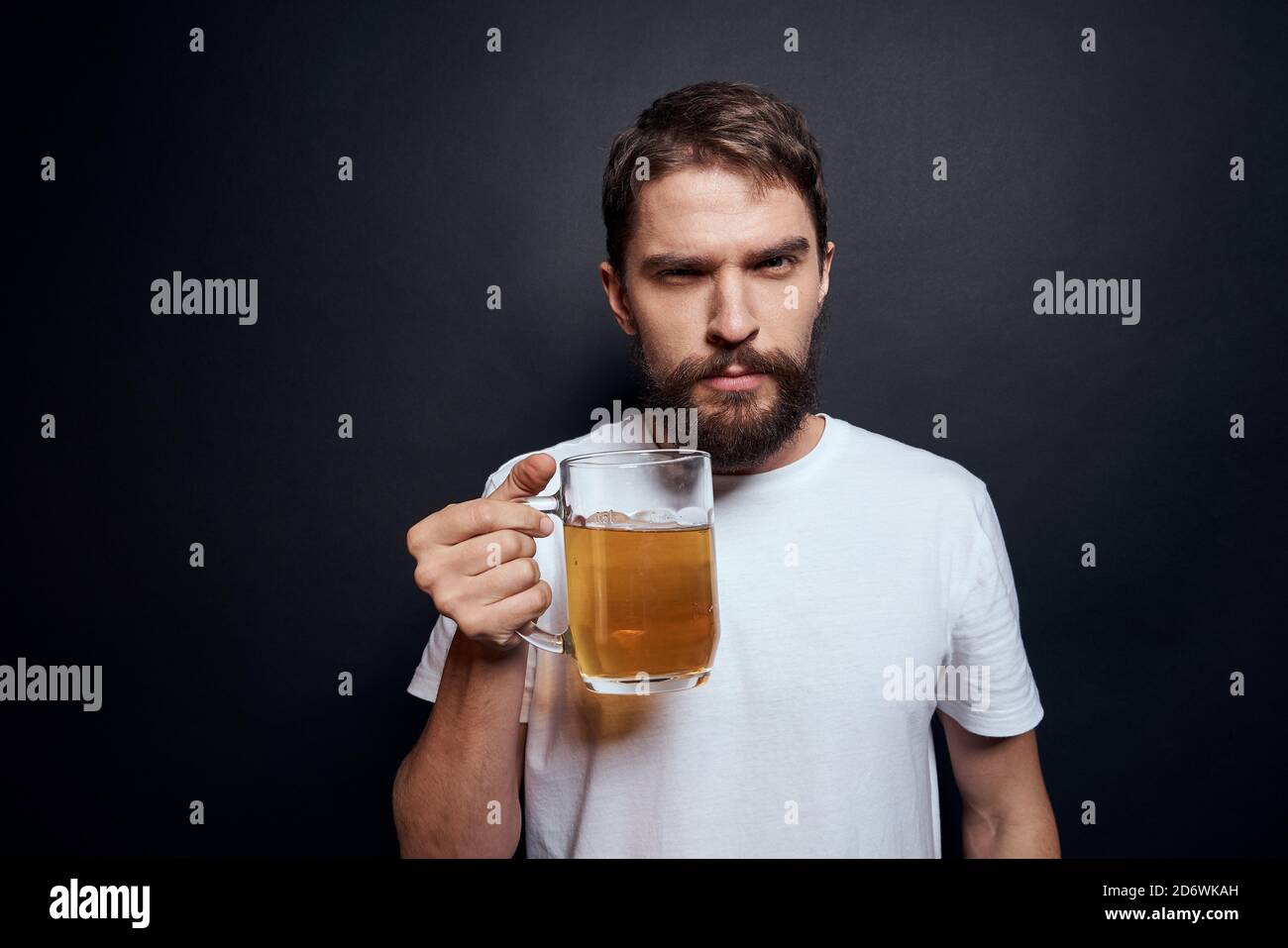 man with a mug of beer in a white tshirt emotions lifestyle drunk on a