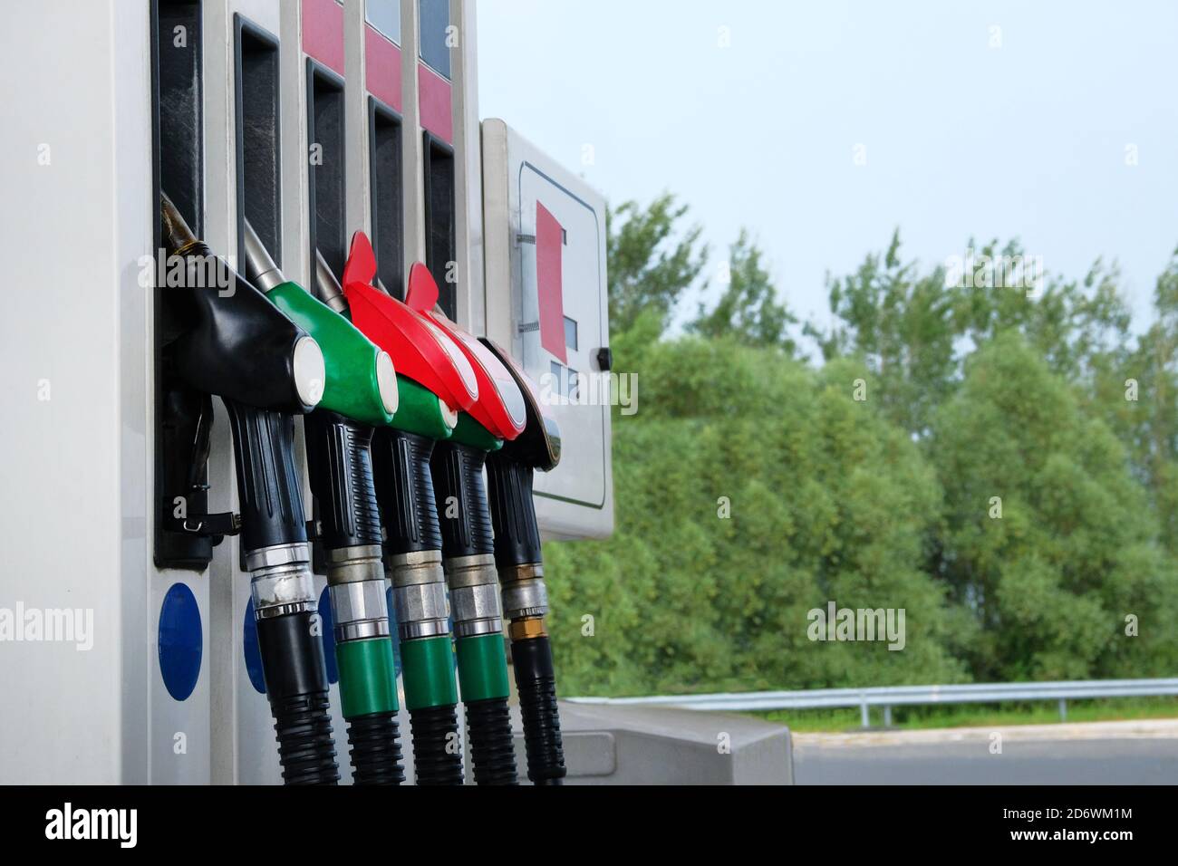 Gasoline and oil products concept. Red and black fuel pistols on fuel station.To fill car with petrol. Close up. Stock Photo