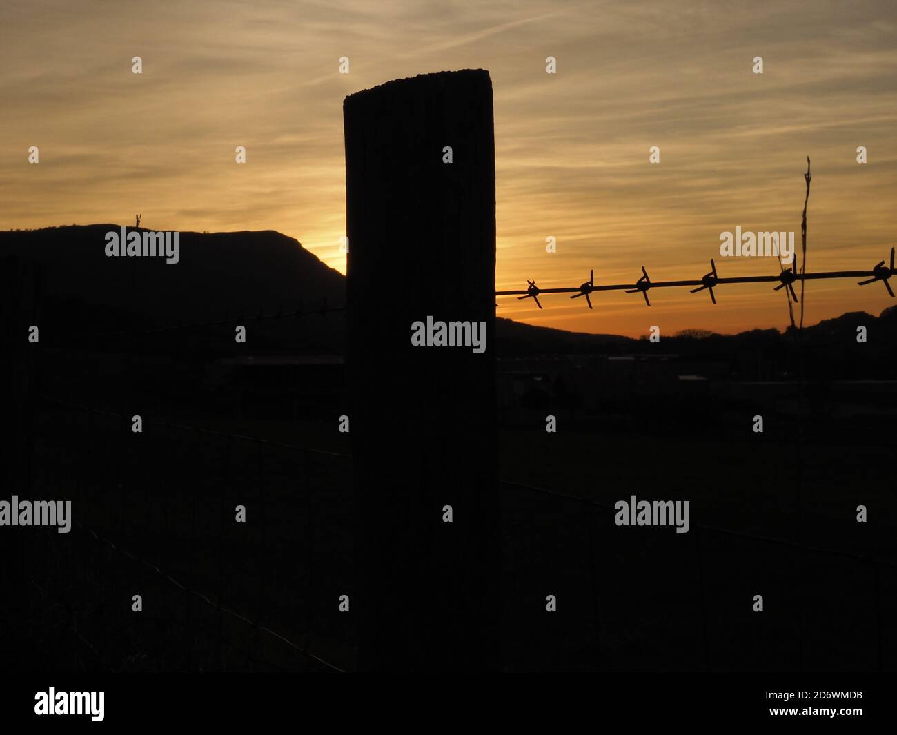 barbed wire with a sunset view behind Stock Photo - Alamy