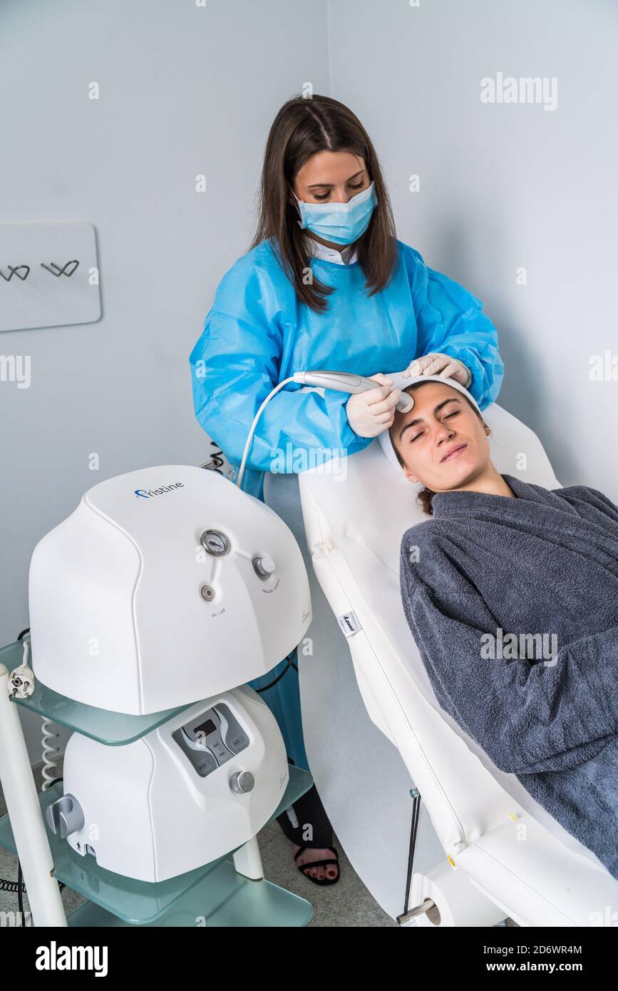 Micro dermabrasion of the face, a technique that eliminates dead cells and impurities from the epidermis, exfoliating the surface layer of the skin, C Stock Photo