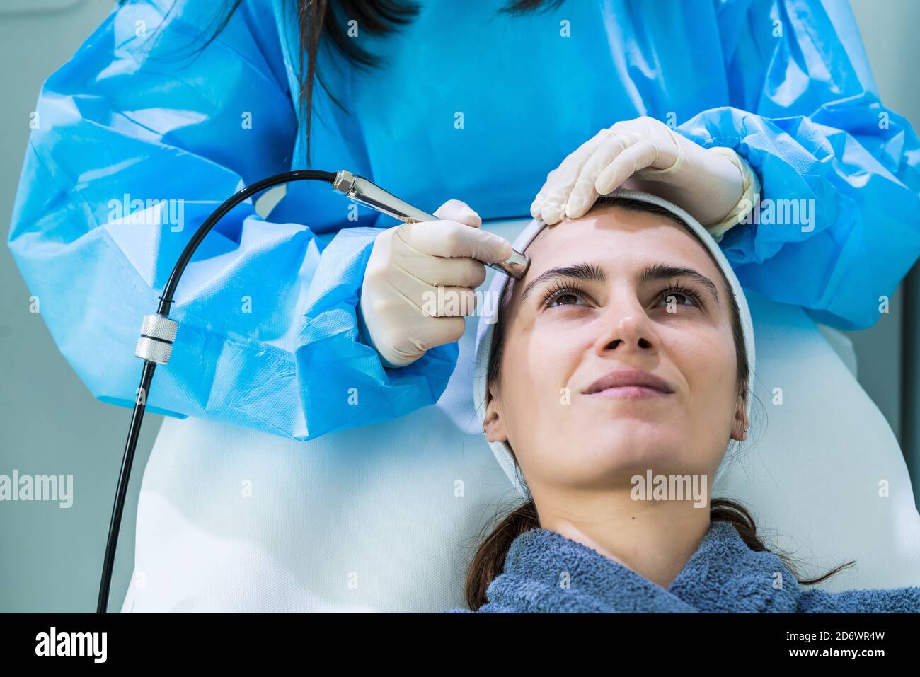 Micro dermabrasion of the face, a technique that eliminates dead cells and impurities from the epidermis, exfoliating the surface layer of the skin, C Stock Photo