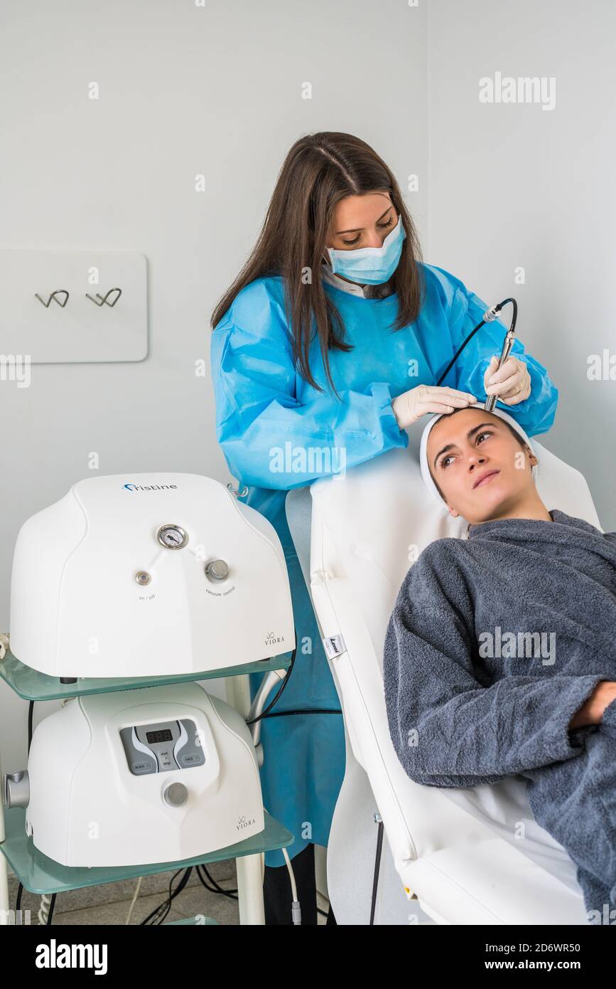 Micro dermabrasion of the face, a technique that eliminates dead cells and impurities from the epidermis, exfoliating the surface layer of the skin, C Stock Photo