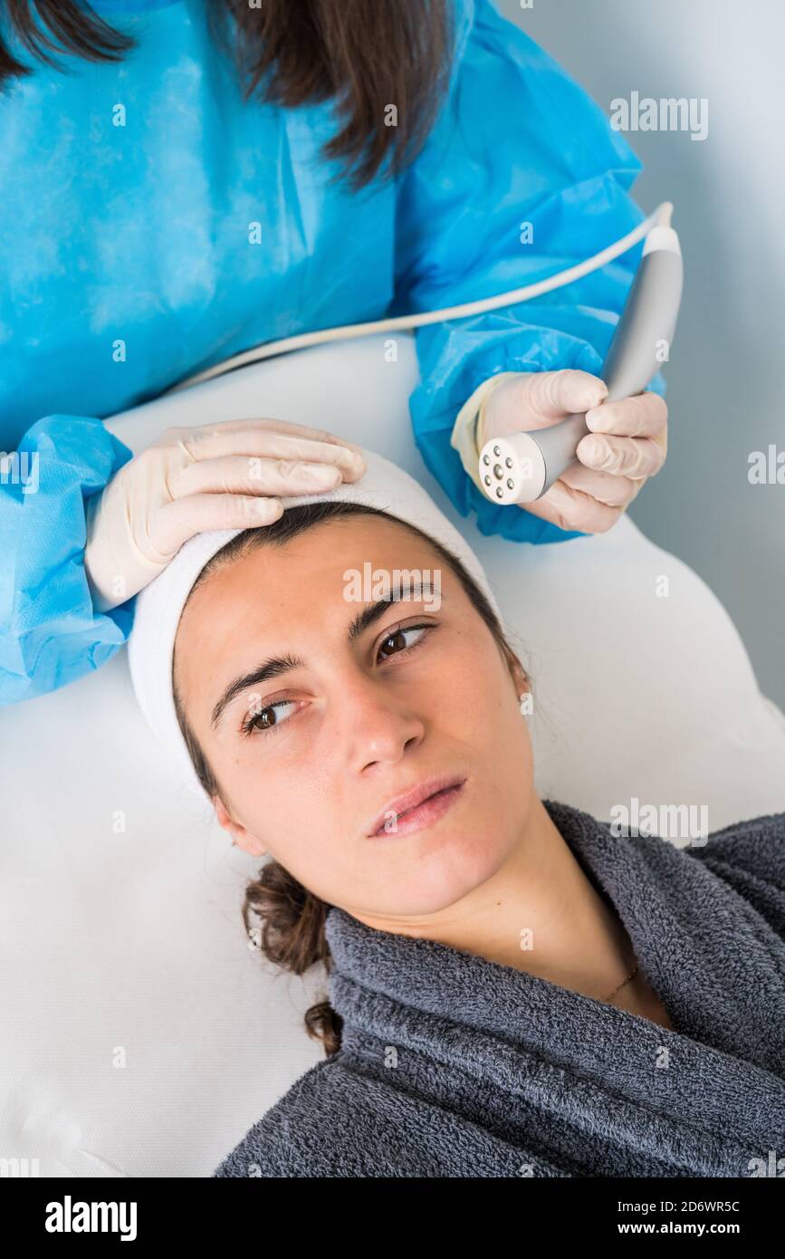 Micro dermabrasion of the face, a technique that eliminates dead cells and impurities from the epidermis, exfoliating the surface layer of the skin, C Stock Photo