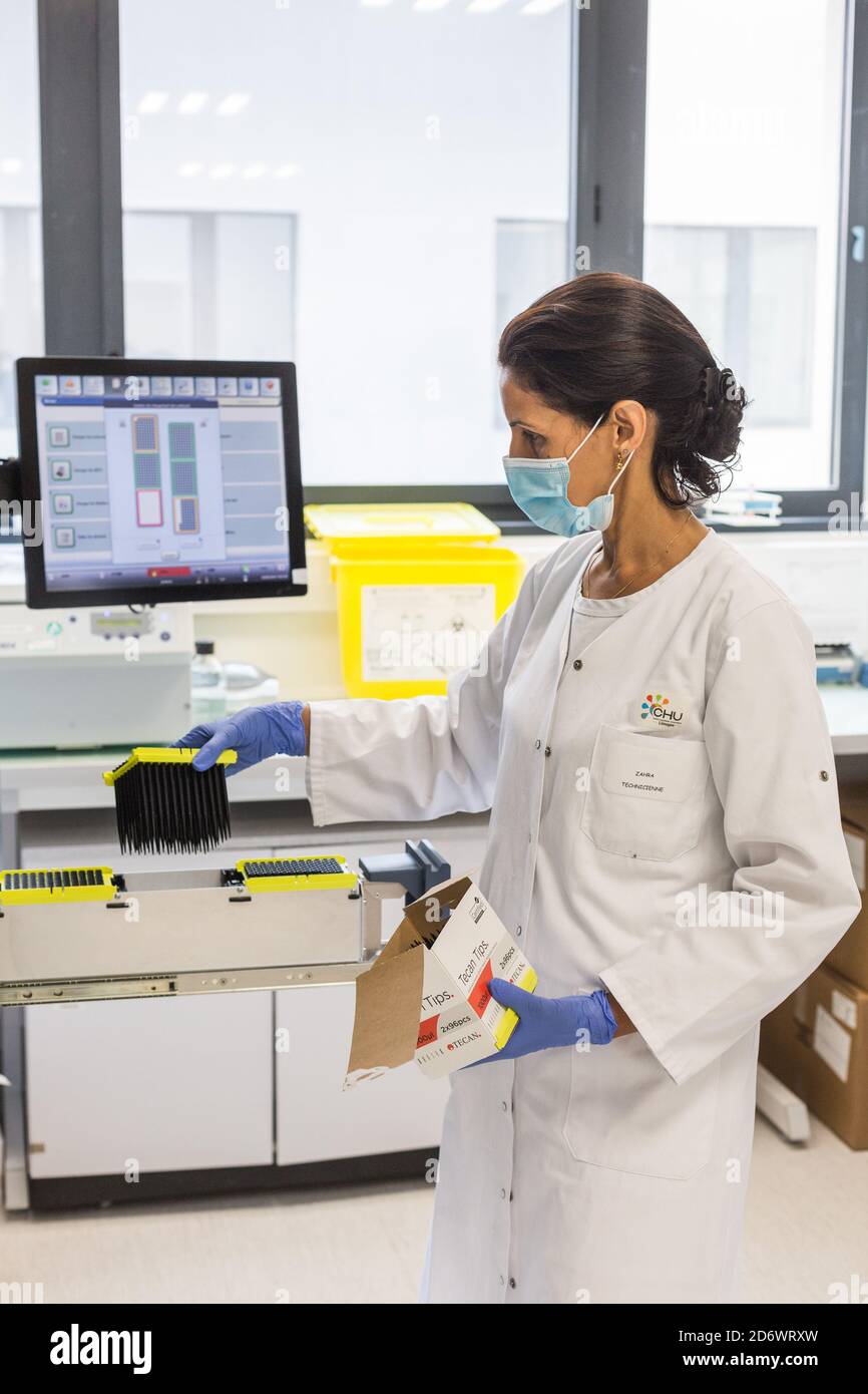 Loading of the reagents of COVID-19 screening PCR test samples in the automatic machine, Limoges hospital analysis laboratory, France. Stock Photo