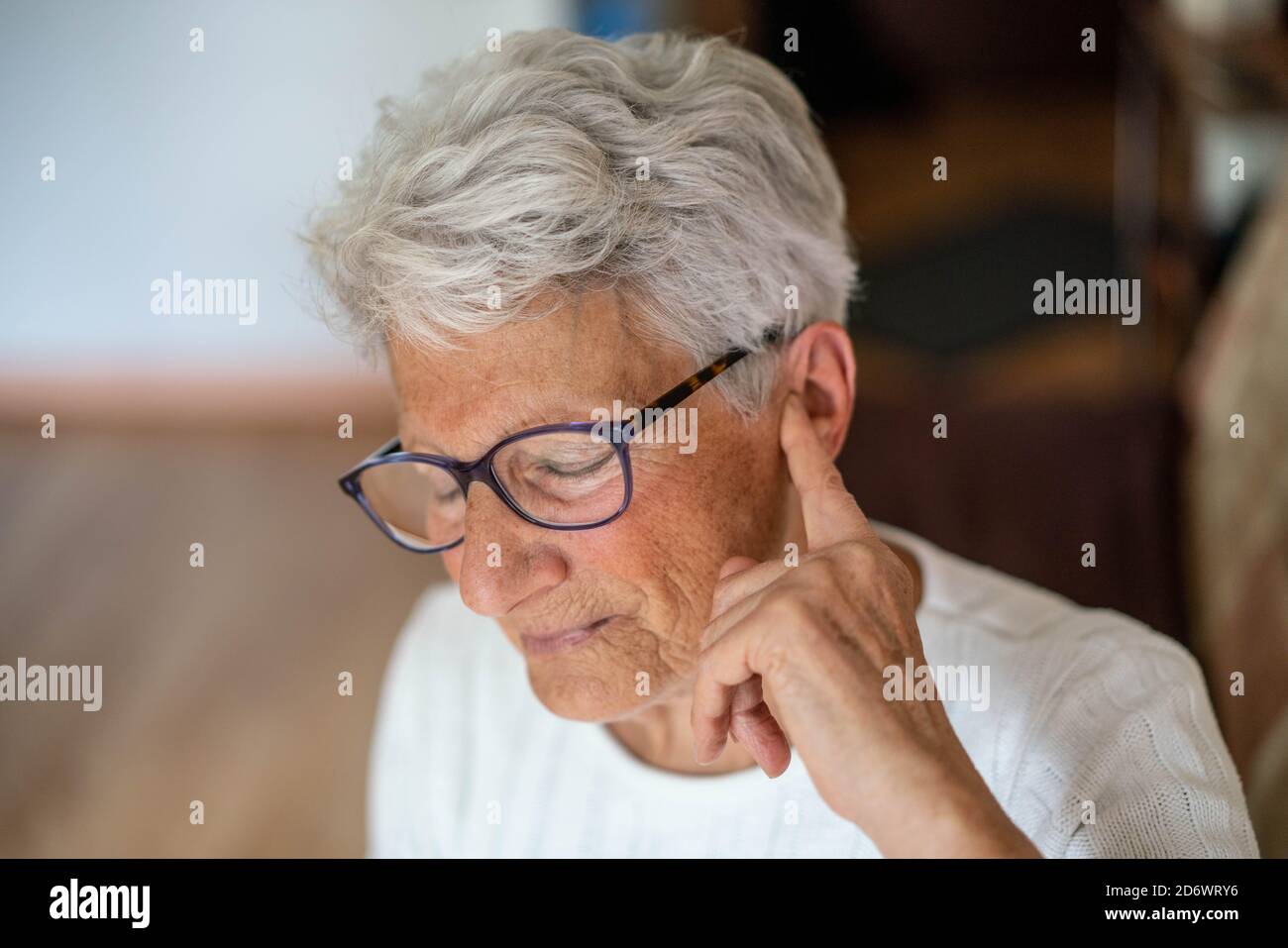 Woman touching her head and ear with earache. Stock Photo