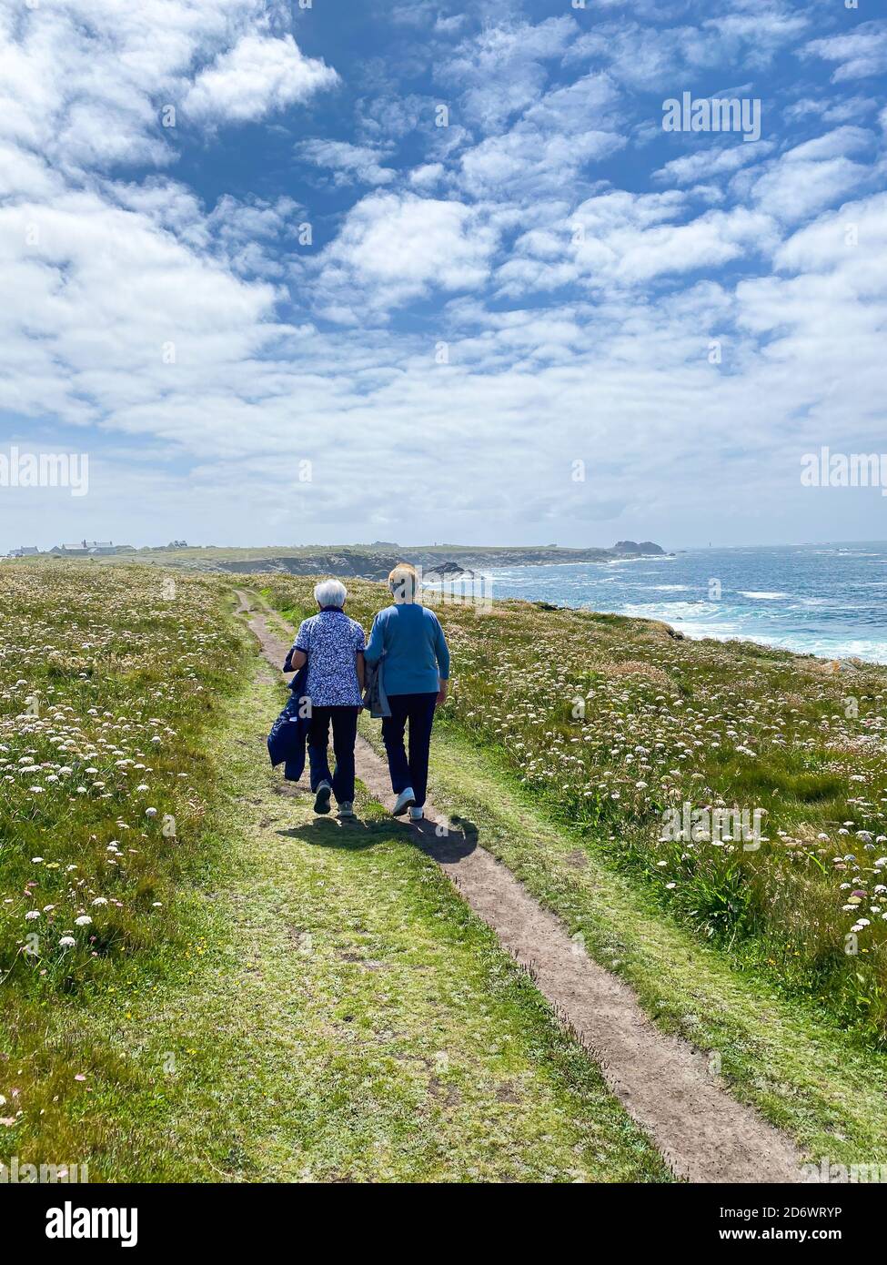 Elderly people walking by the sea. Stock Photo