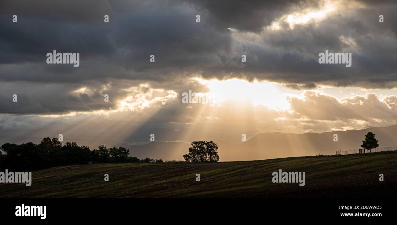 Beautiful sunrise with sun rays breaking through the clouds ...