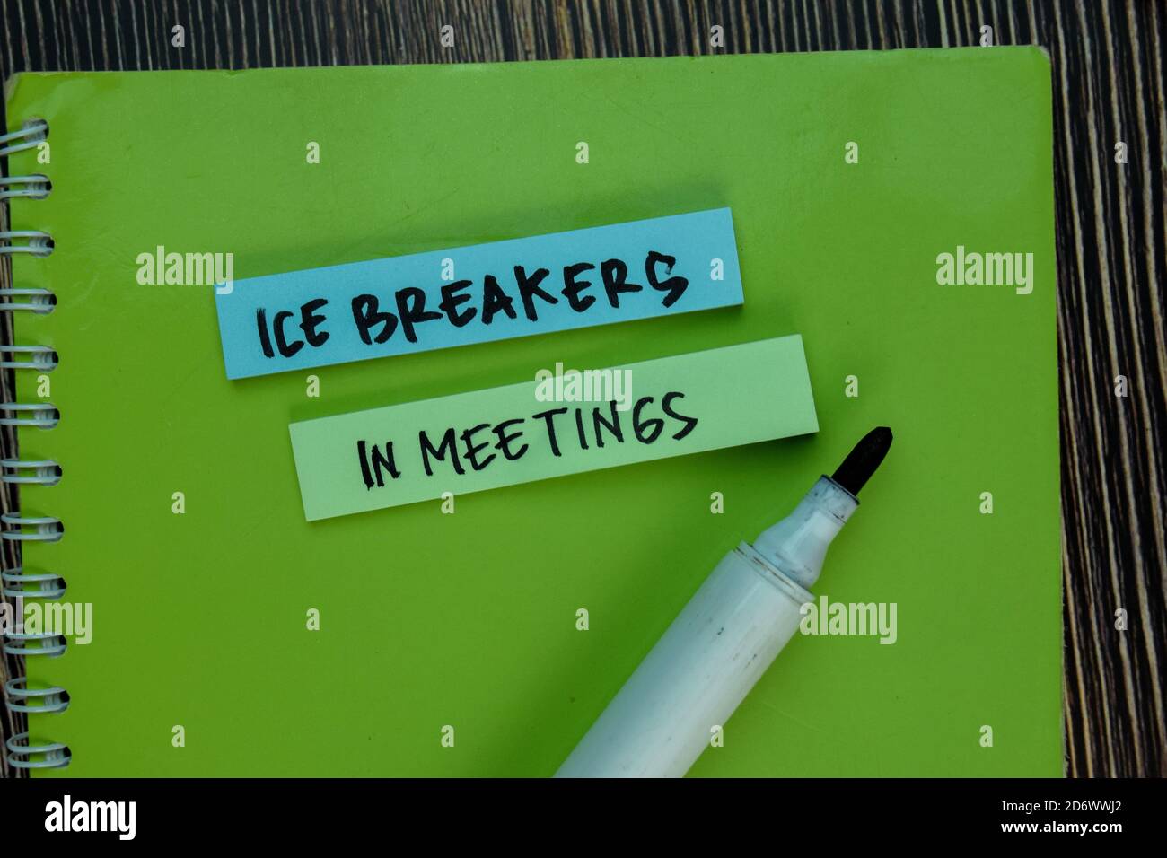 Ice Breakers in Meetings write on sticky notes isolated on Wooden Table ...