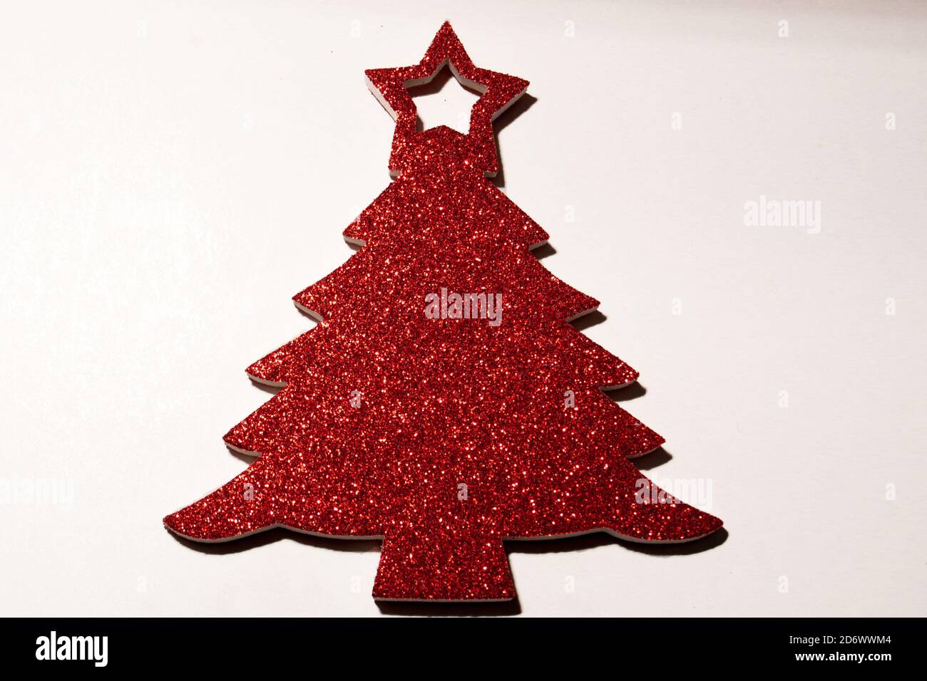 isolated red christmas tree with glitters on white background Stock Photo