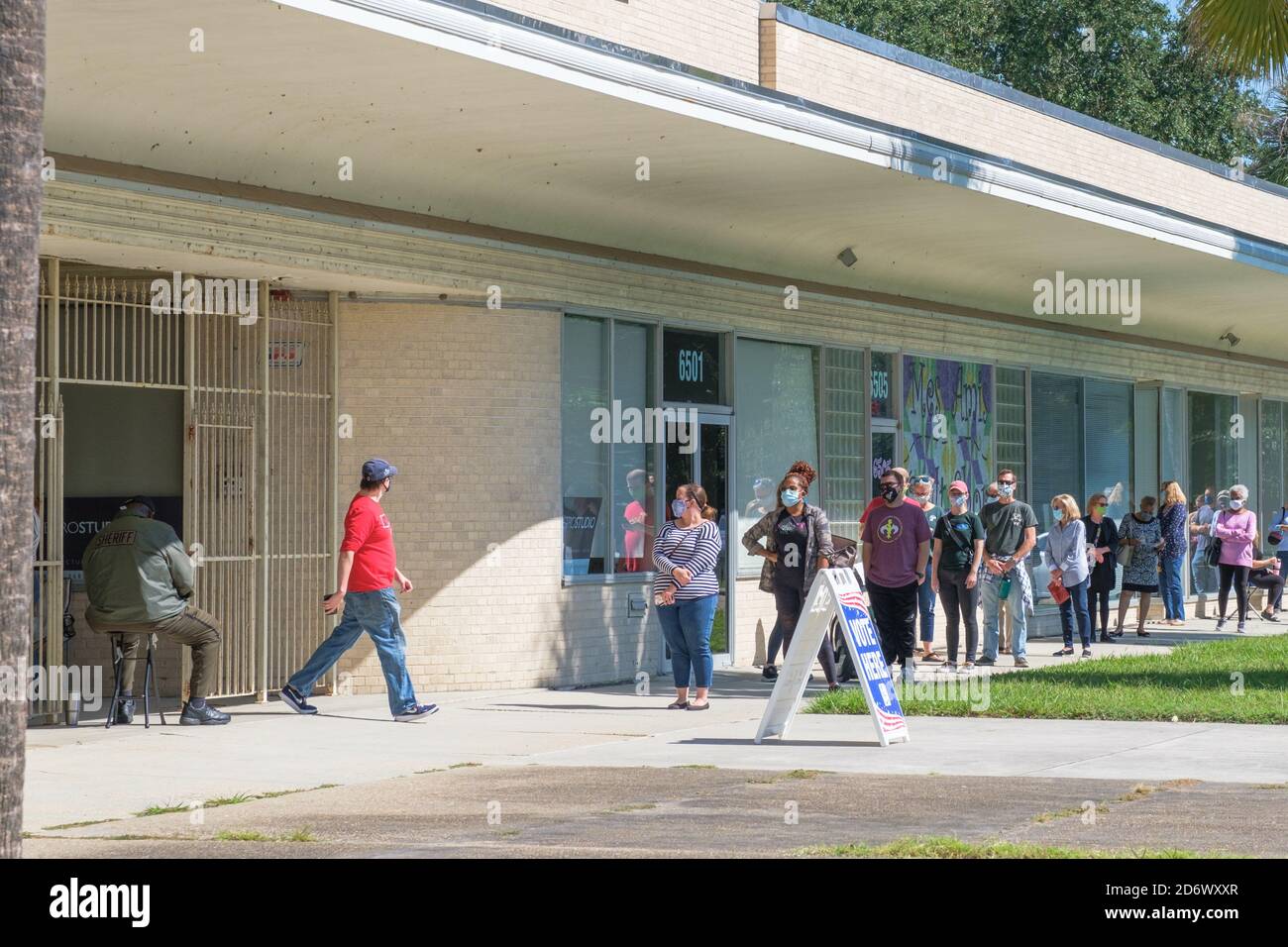 New Orleans, Louisiana/USA - 10/17/2020 Line for Voting at Lake Vista Polling Place with One Man Exiting Stock Photo