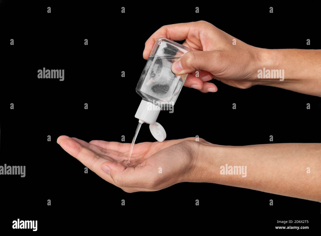 Portable small hand sanitizer bottle. Woman using to go dispenser for clean hands while commuting or shopping Stock Photo