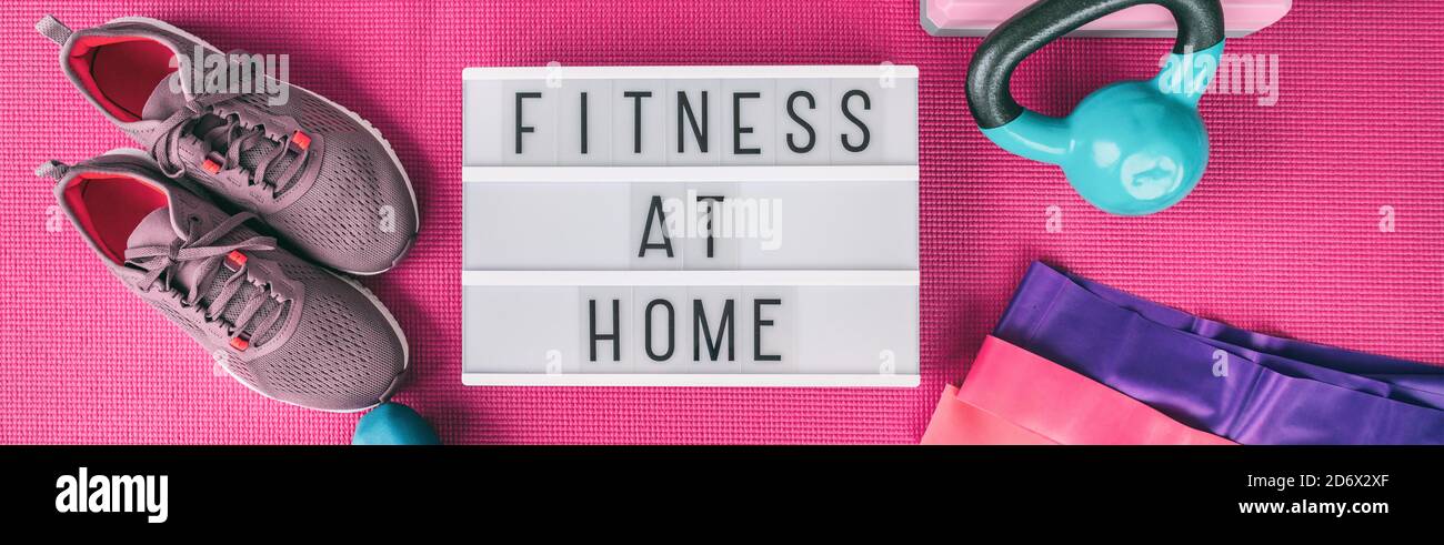 Fitness at home exercise training with weights and resistance bands banner . Running shoes and kettlebell top view of lightbox sign with text for Stock Photo