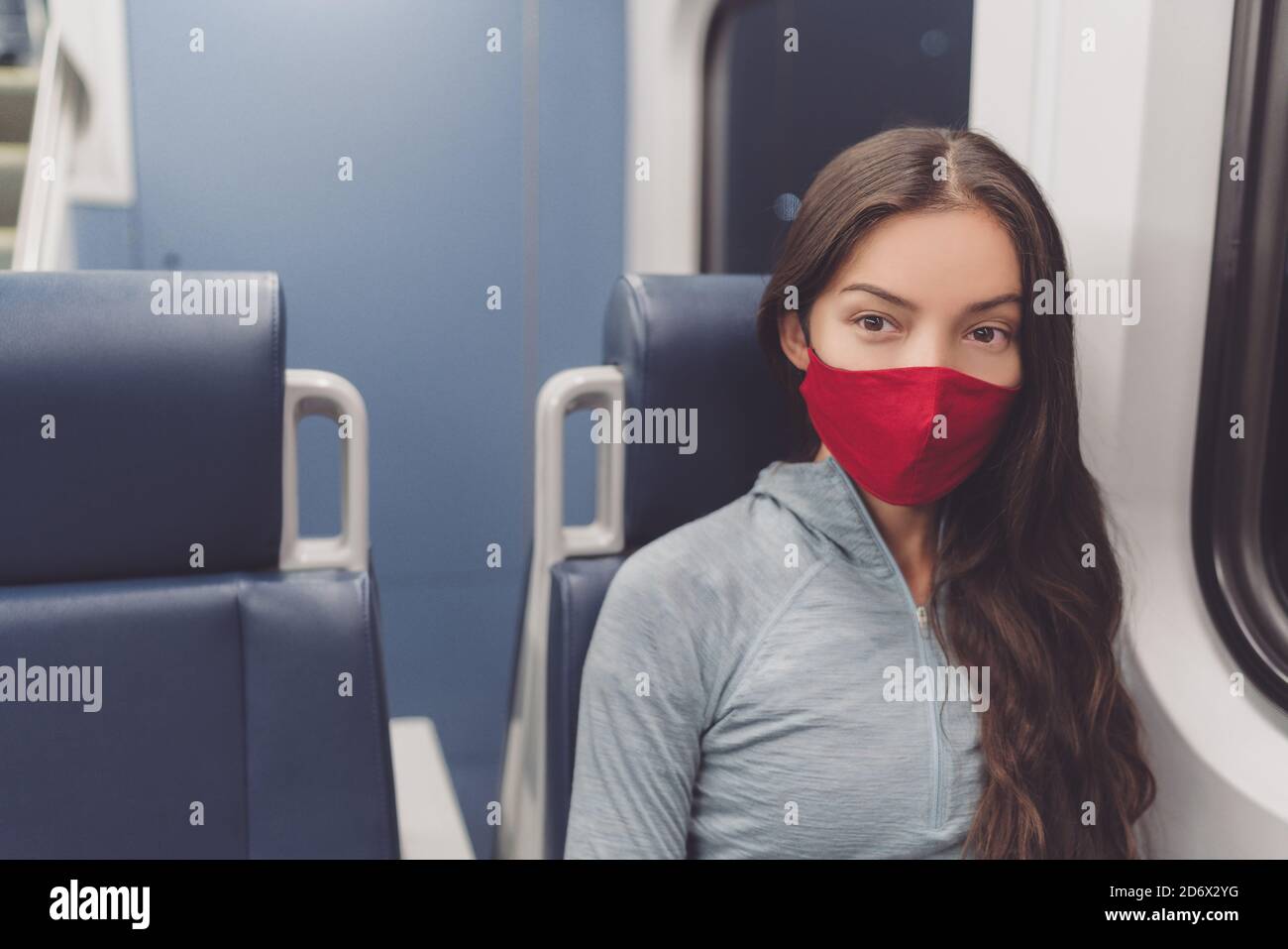Woman wearing face mask in public transportation during coronavirus