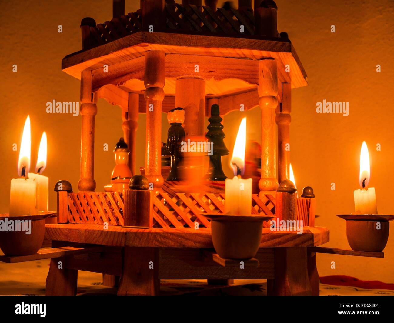 Closeup of Christmas pyramid with lit candles - Figures in the center are captured in motion Stock Photo