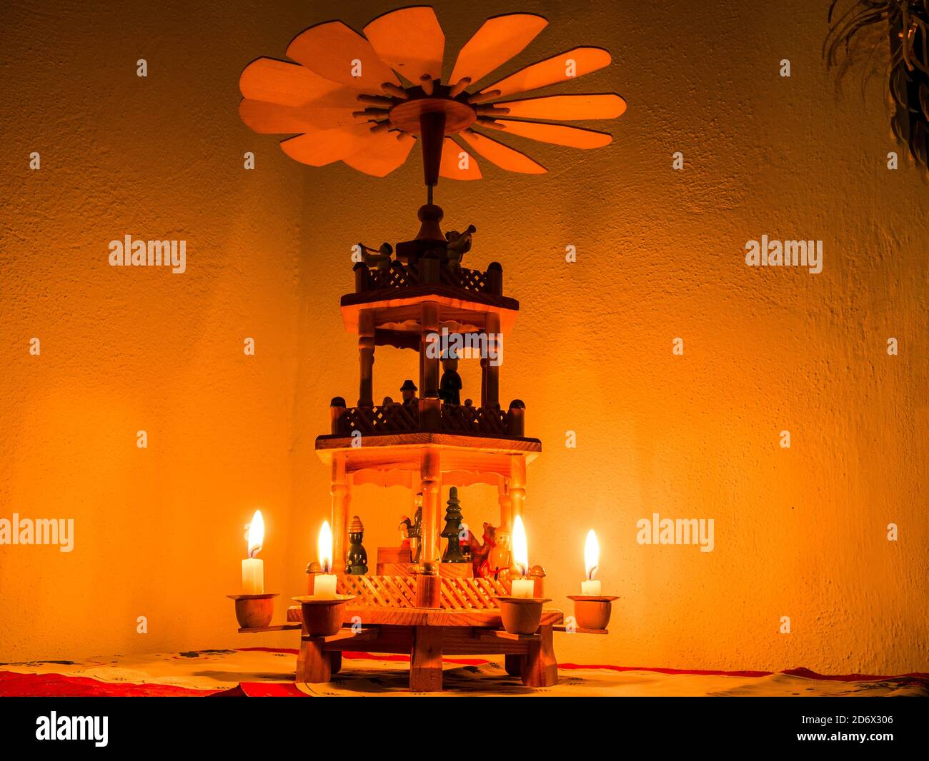 Christmas pyramid with lit candles - warm air from candles spinning propeller on top Stock Photo
