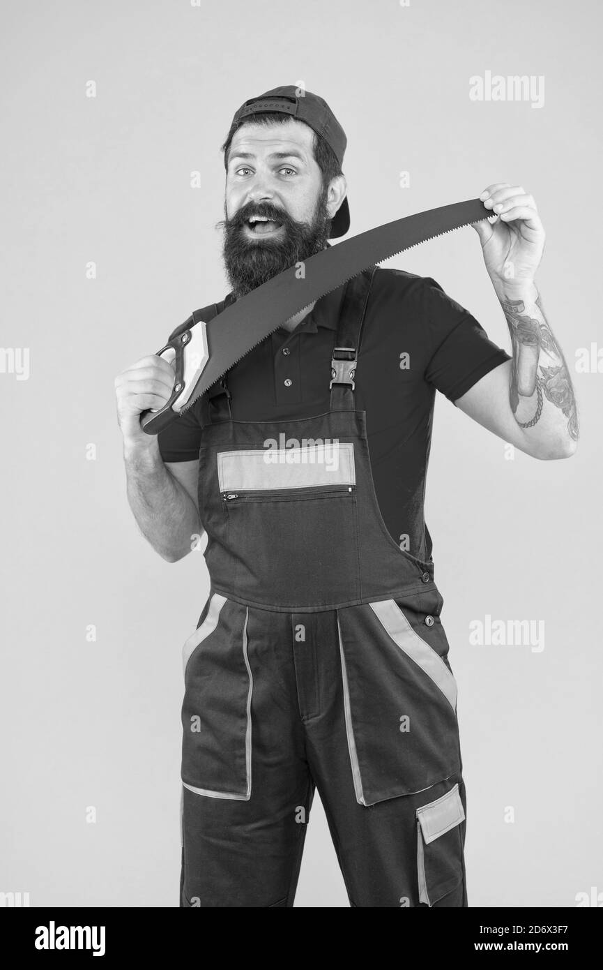 Production of stairs door and window frames. Reliable tool. Builder working with saw. Worker