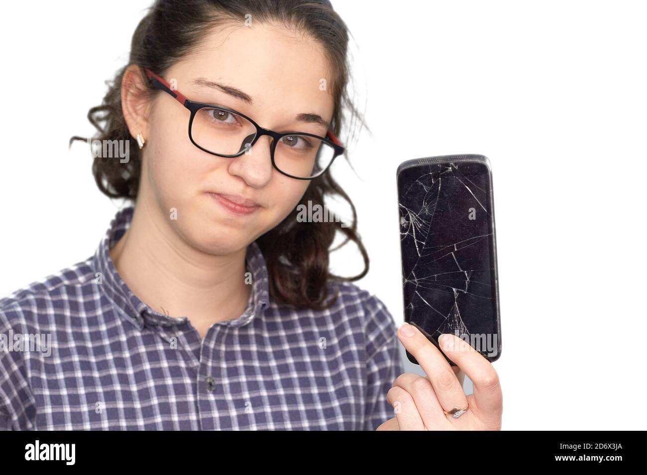 Broken glass screen smartphone in hand of upset girl. Stock Photo