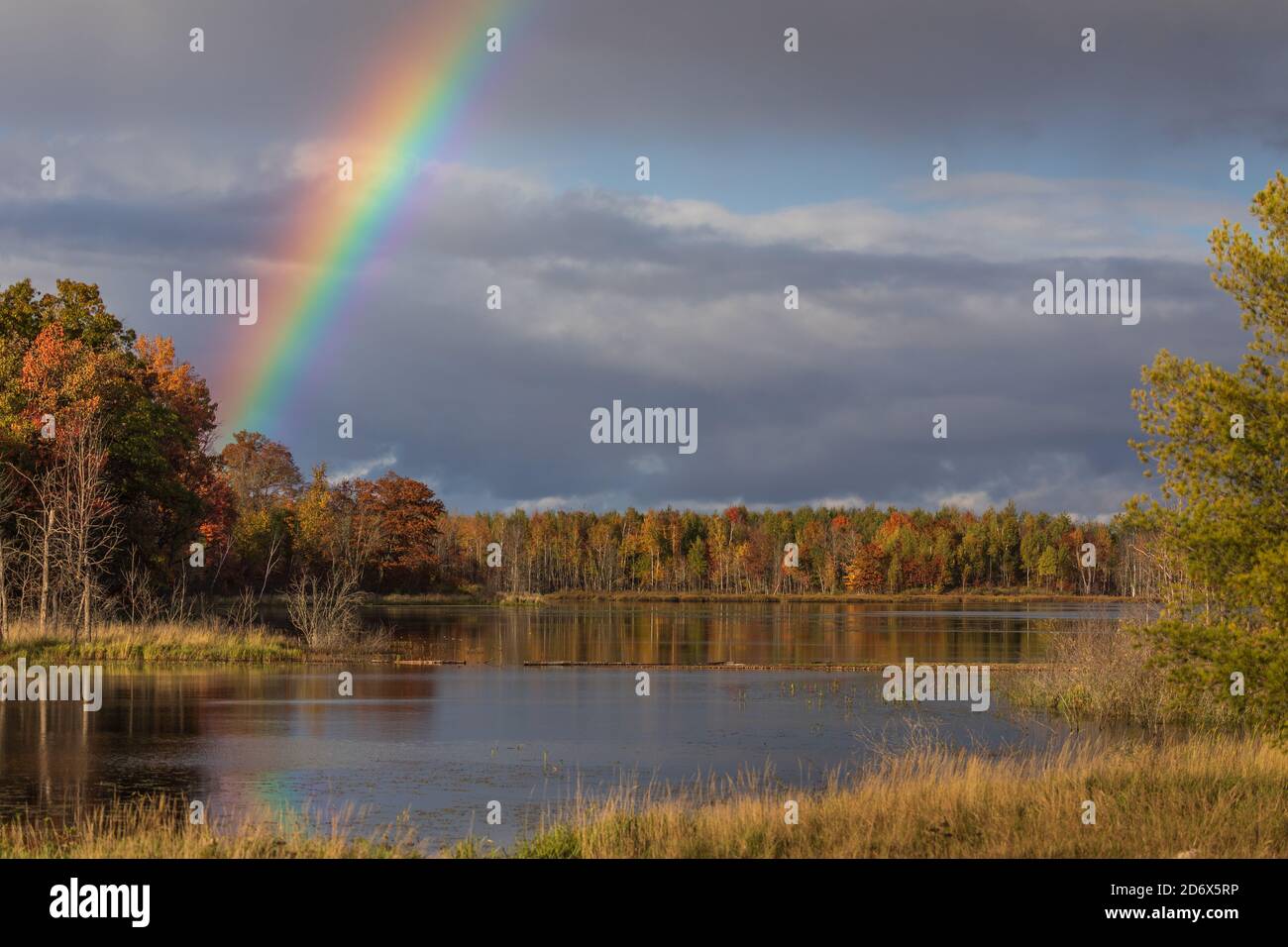 A pretty rainbow over a wilderness lake in northern Wisconsin. Stock Photo