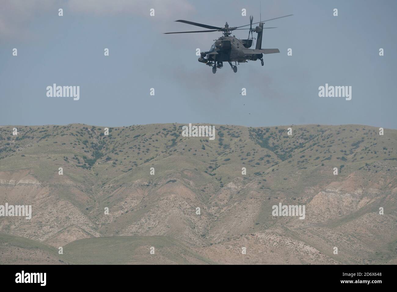 A U.S. AH-64 Apache helicopter fires away during a call to fire training with U.S. Soldiers from the 4th Squadron, 2d Cavalry Regiment and 12th Combat Aviation Brigade at the Vaziani Training Area, Georgia, Sept. 14, 2020.     The 4/2 Soldiers successfully completed their training exercise at the Vaziani Training Area in Georgia from September 7th to September 18th. Designed to enhance regional partnerships and increase U.S. force readiness and interoperability, the exercise allows participants to conduct sniper and demo ranges, situational training exercises, live-fire exercises and combined Stock Photo