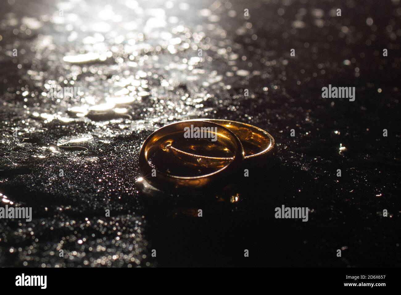 Two golden wedding rings on black background Stock Photo Alamy