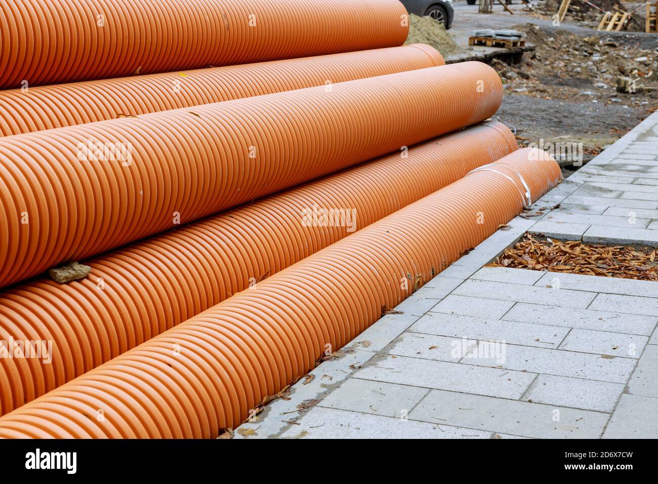 Plastic PVC pipes stacked in rows at construction site on ...