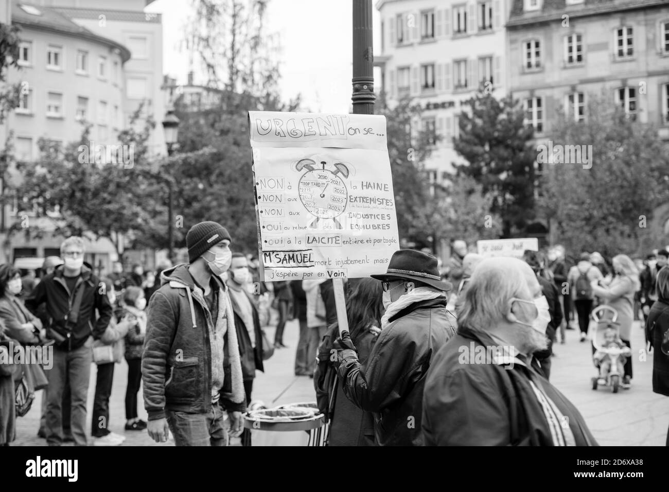 Strasbourg, France - Oct19, 2020: Man with placard in Place Kleber to pay tribute to history teacher Samuel Paty, beheaded on Oct16th after showing caricatures of Prophet Muhammad in class Stock Photo