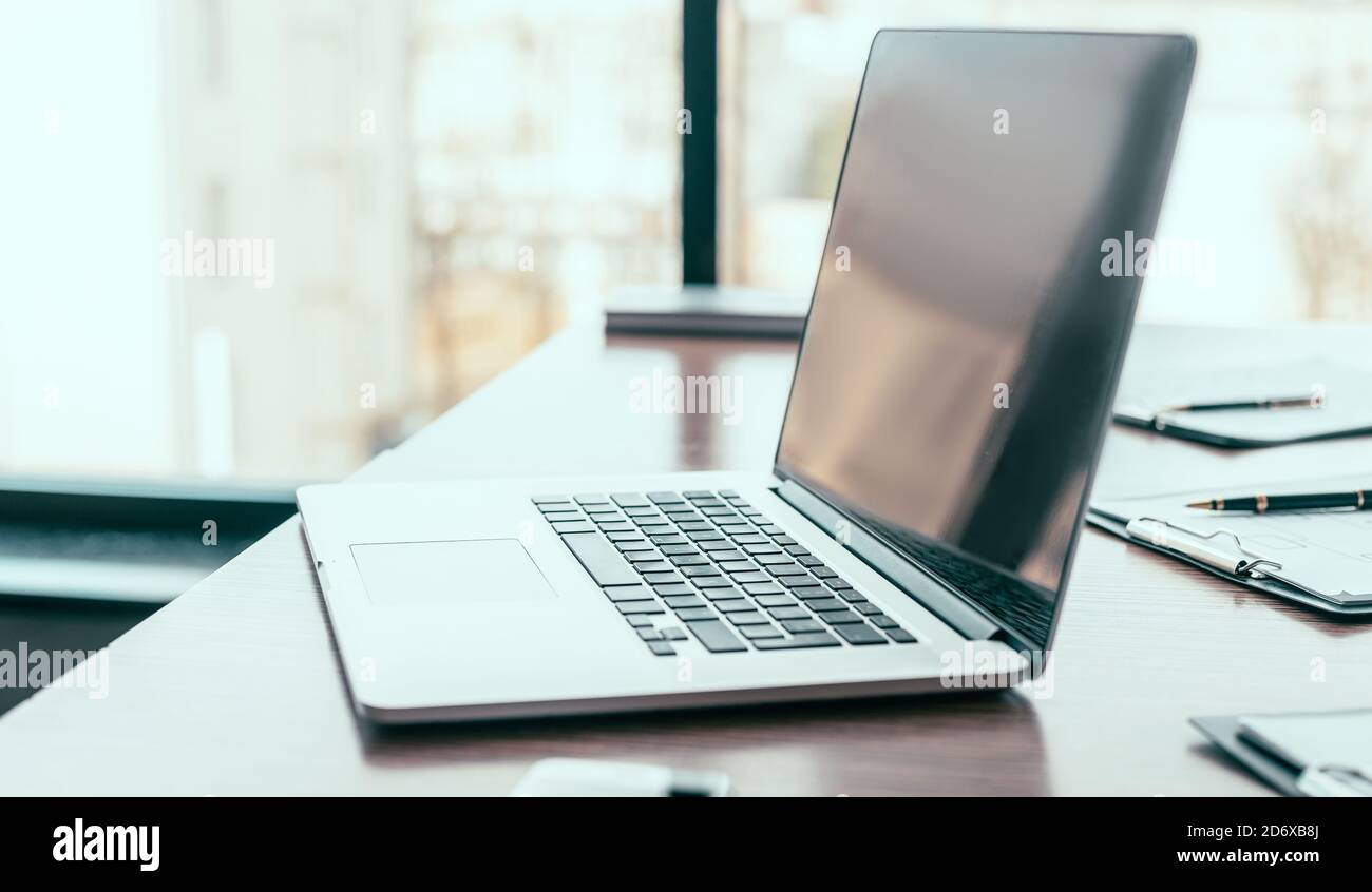 side view. open laptop on the office Desk Stock Photo - Alamy