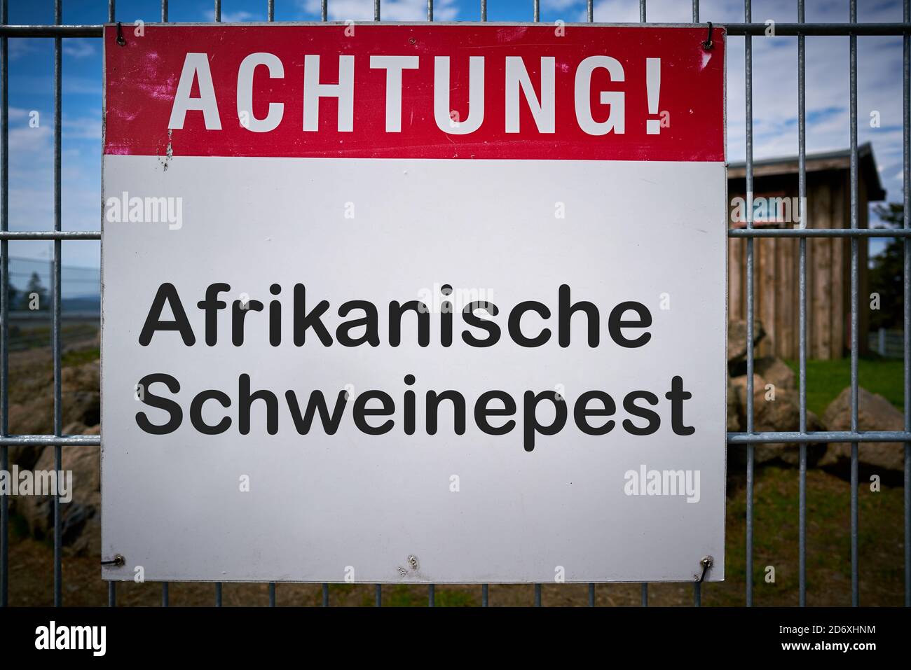 Sign with the inscription 'Achtung Afrikanische Schweinepest' (Attention African swine fever) on a fence to a farm in Germany Stock Photo