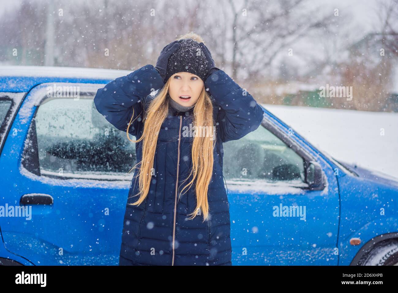 The woman was very froze in winter under snowfall. Winter problems Stock Photo
