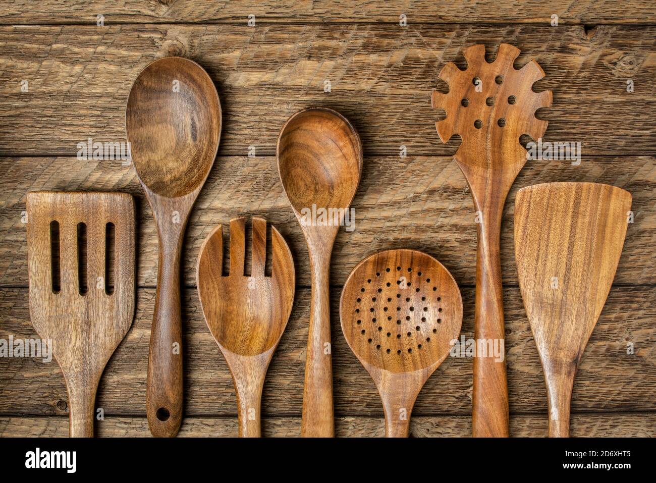 wooden kitchen cooking utensils set on a rustic weathered barn wood