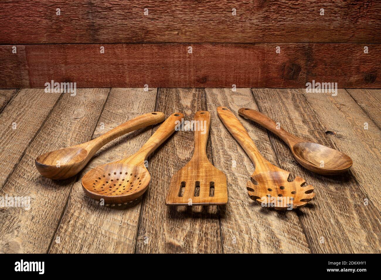 wooden kitchen cooking utensils set on a rustic weathered barn wood background Stock Photo