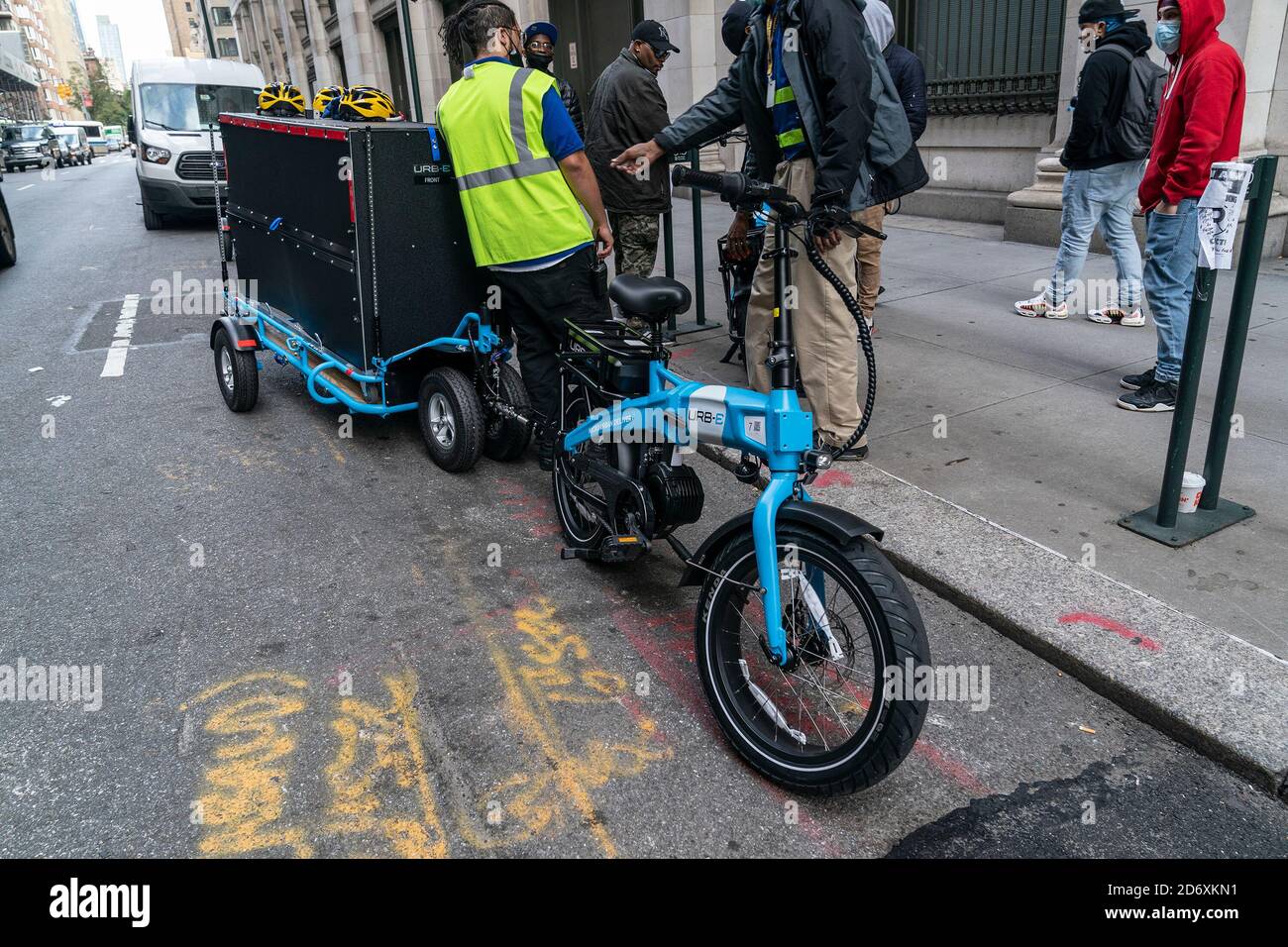 Amazon employees receive lesson on usage of Urb-E bikes for delivery in New  York. In order to make delivery more efficient and reduce greenhouse gas  emissions by cars Amazon will start delivery