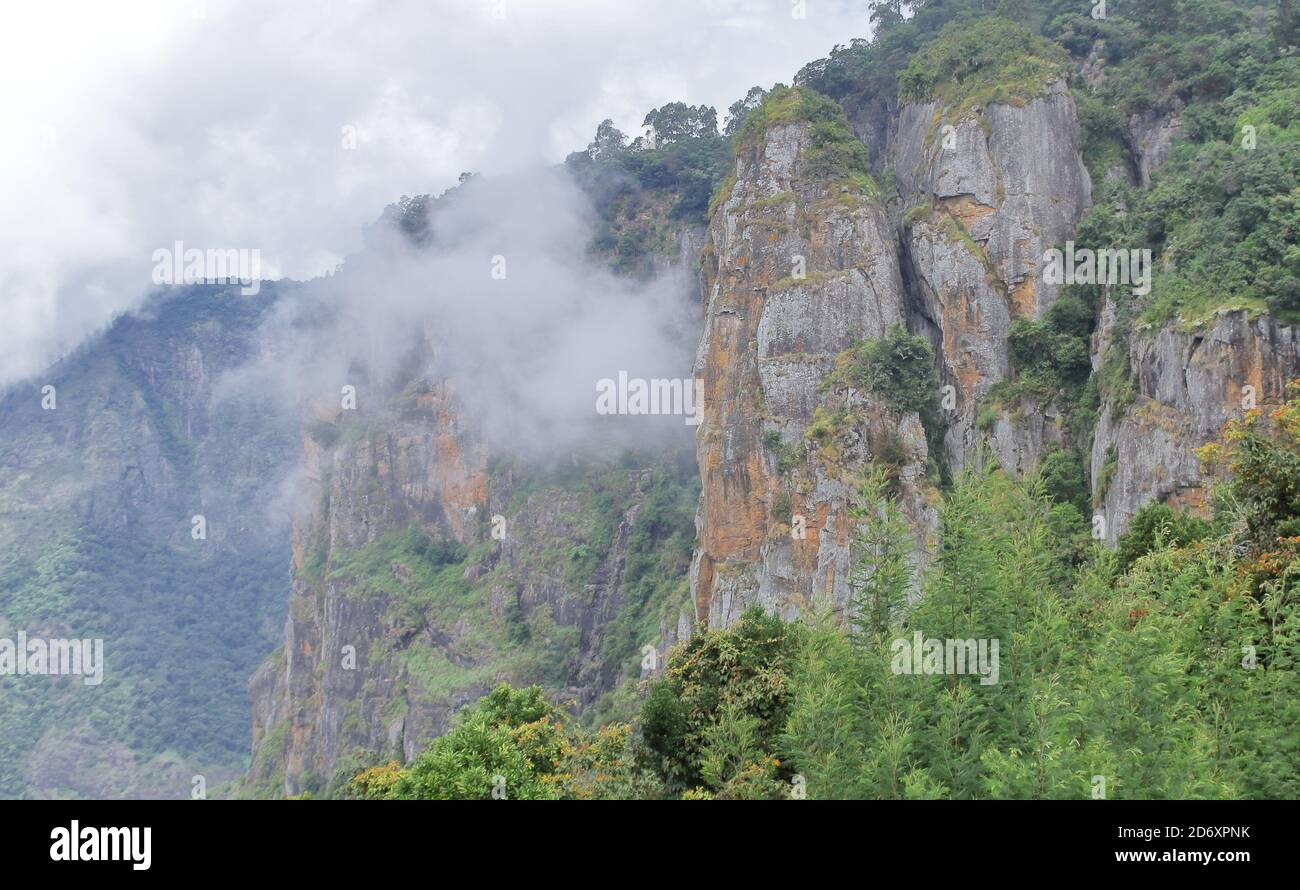 scenic cloudy view of palani hills and pillar rock from a view point at kodaikanal in tamilnadu, south india Stock Photo