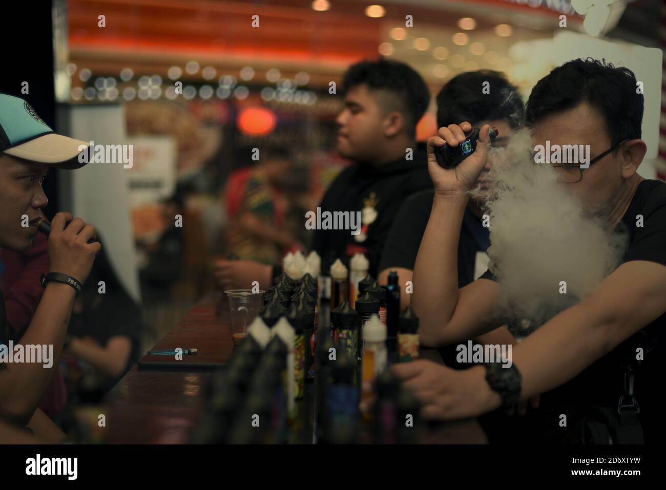 Vape Rally E-cigarette users trying liquids at a stall during a vape fair in South ...