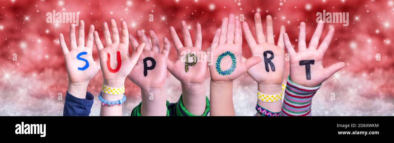 Children Hands Building Word Support, Red Christmas Background Stock Photo