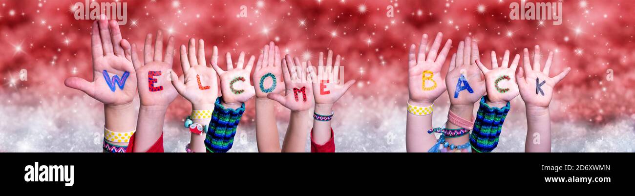 Children Hands Building Word Welcome Back, Red Christmas Background Stock Photo