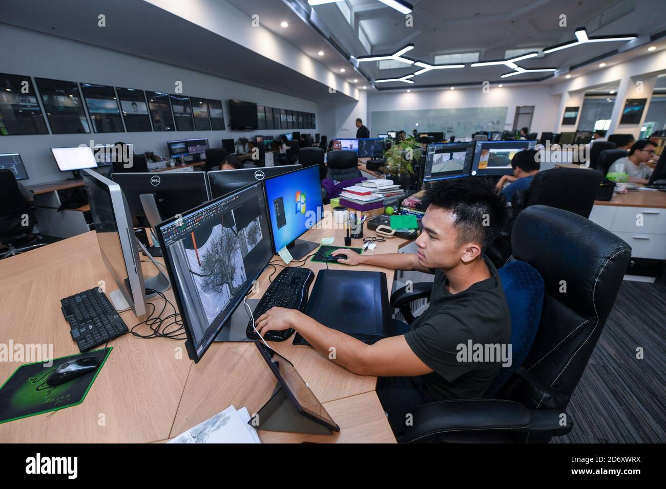 (201020) -- SHENZHEN, Oct. 20, 2020 (Xinhua) -- An animation designer of Shenzhen Dans Digital Technology Ltd. works at the company in Shenzhen, south China's Guangdong Province, Oct. 16, 2020. Along with 40 years of rapid economic growth, Shenzhen, China's first and most successful special economic zone, has also achieved cultural prosperity. As early as 2003, Shenzhen took the lead in proposing the strategy of making the city culture-nurtured. In 2008, Shenzhen was designated as a UNESCO City of Design, clarifying the transformation of strategic development goal from promoting manufacturing Stock Photo
