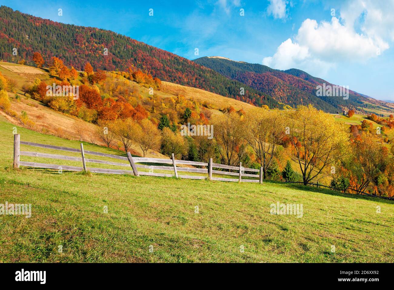 rural landscape in mountains. fence on the hill. scenery in fall colors ...