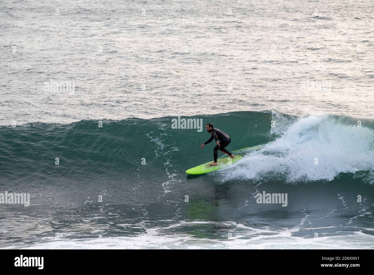 Surfer in Porthleven, Cornwall England UK Stock Photo