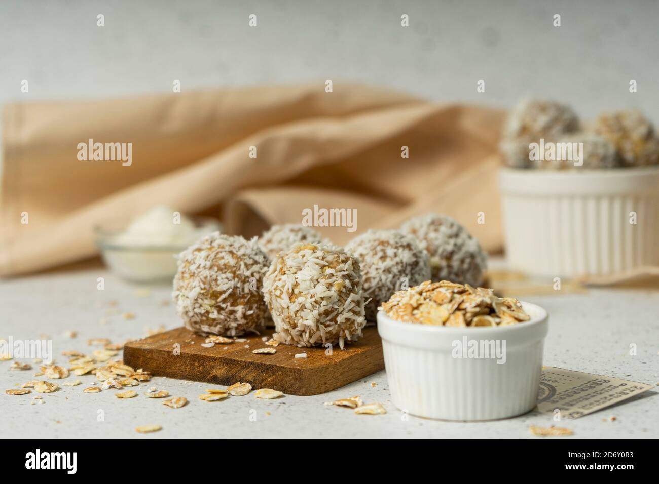 energy balls, whole oat flakes and coconut powder, low-calorie sweets, on a light background Stock Photo