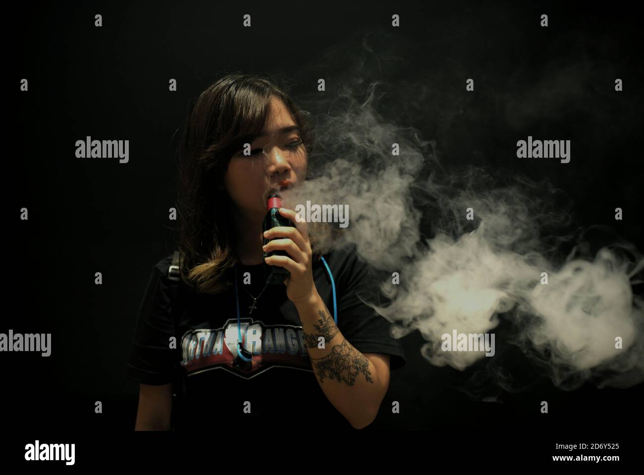 Portrait of woman vape cloud performer, Deborah Chen, during the annual Vape Fest in Jakarta, Indonesia. Stock Photo