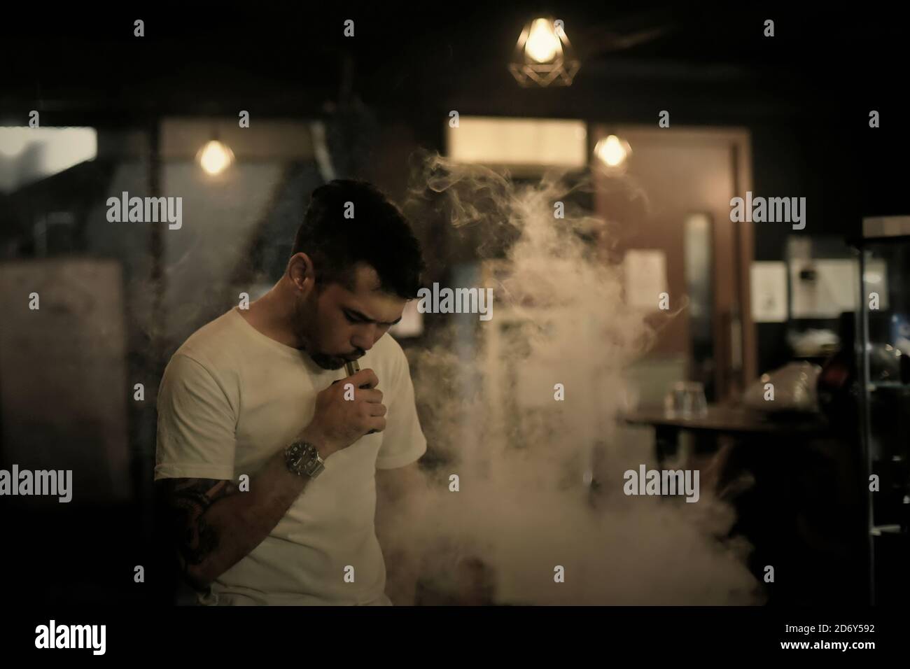 Jason Stachursky, a vape store manager, enjoying his favourite e-cigarette vapour inside his famous store in South Jakarta, Jakarta, Indonesia. Stock Photo